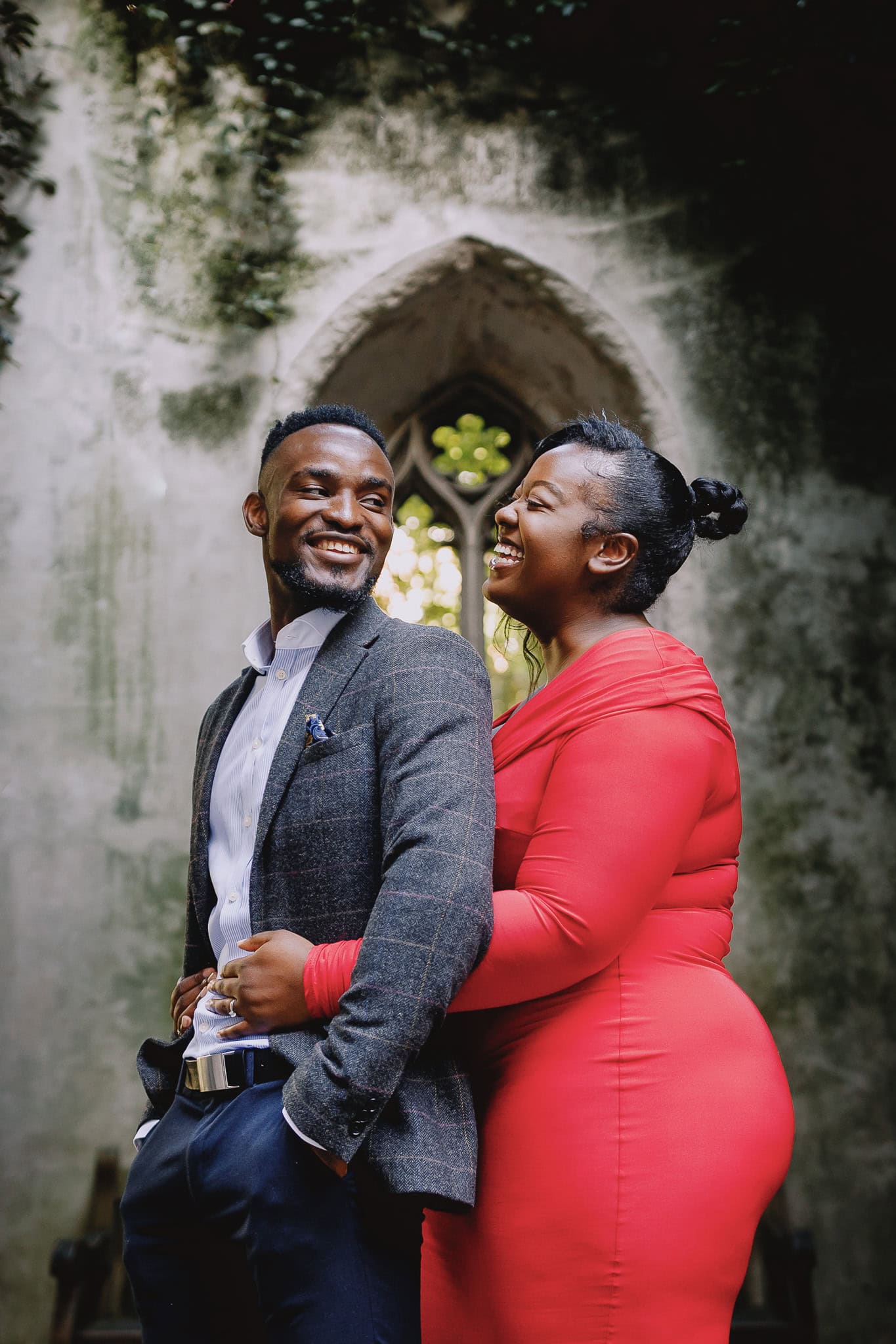 Happy couple embracing during their pre-wedding shoot, laughing together.