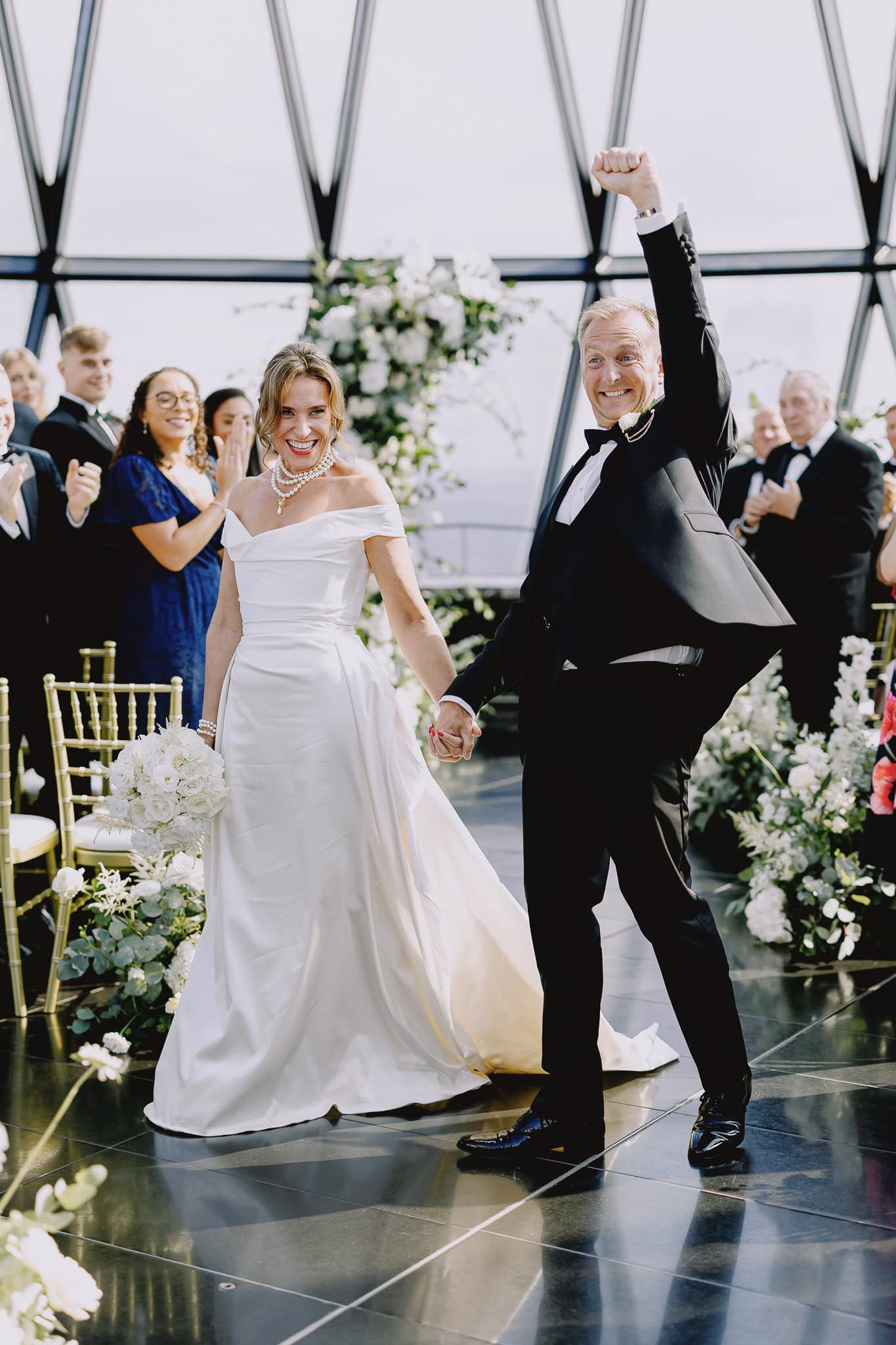 Newlyweds joyfully exit wedding ceremony, editorial wedding photography.