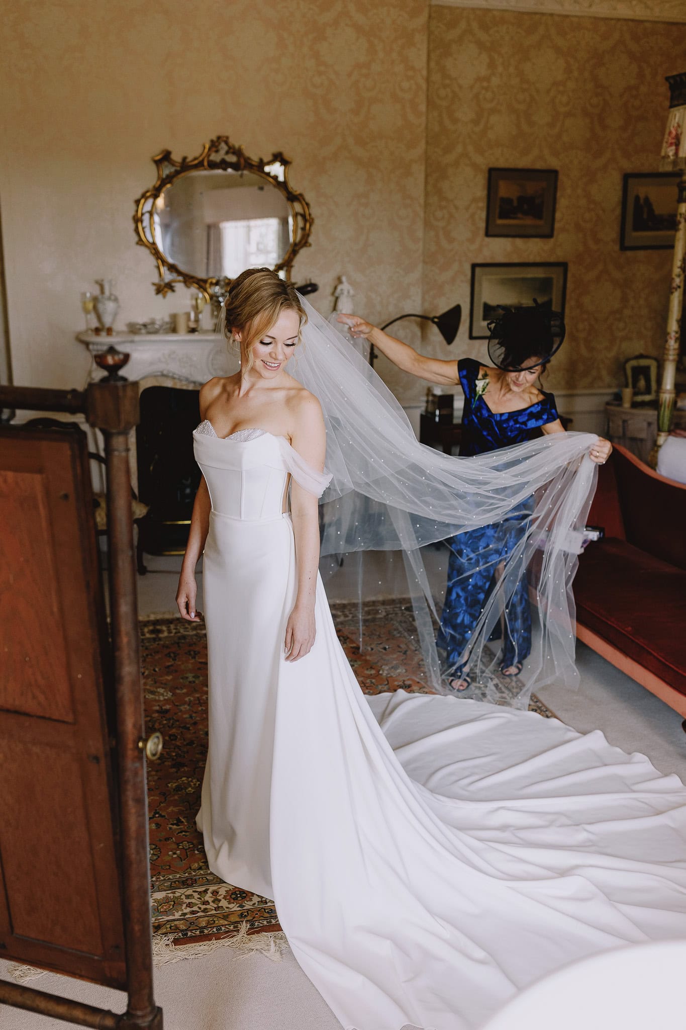Bride getting veil placed for editorial wedding photography.