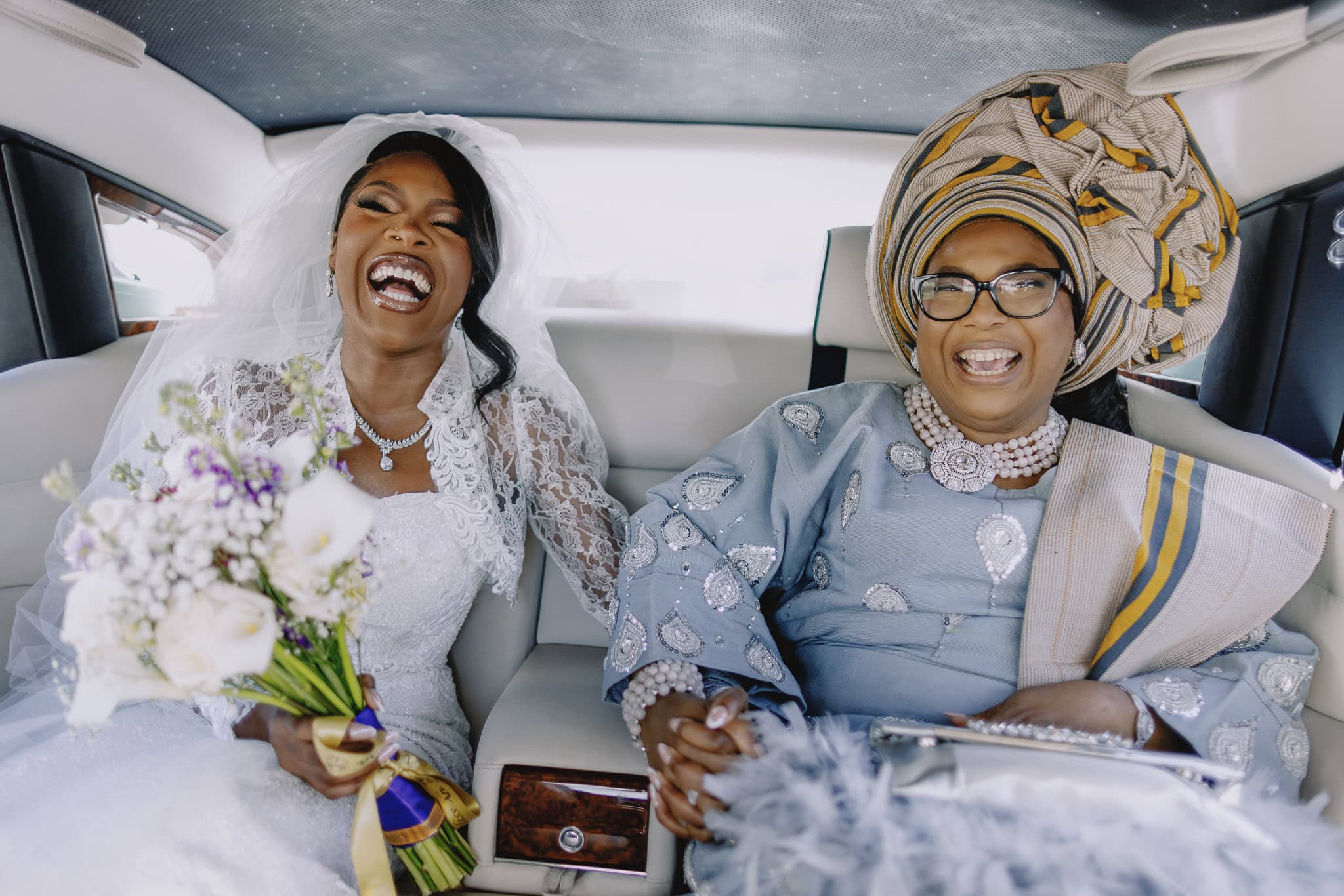 Joyful bride and mother in limousine, part of a wedding photography portfolio.