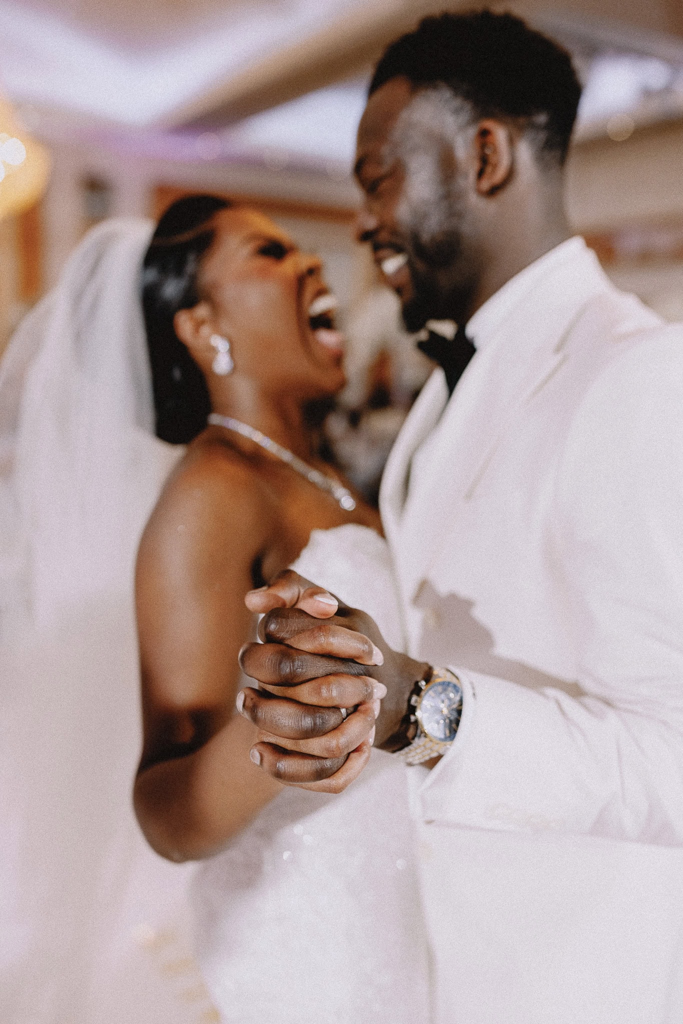Joyful Black couple celebrating their wedding with a first dance.