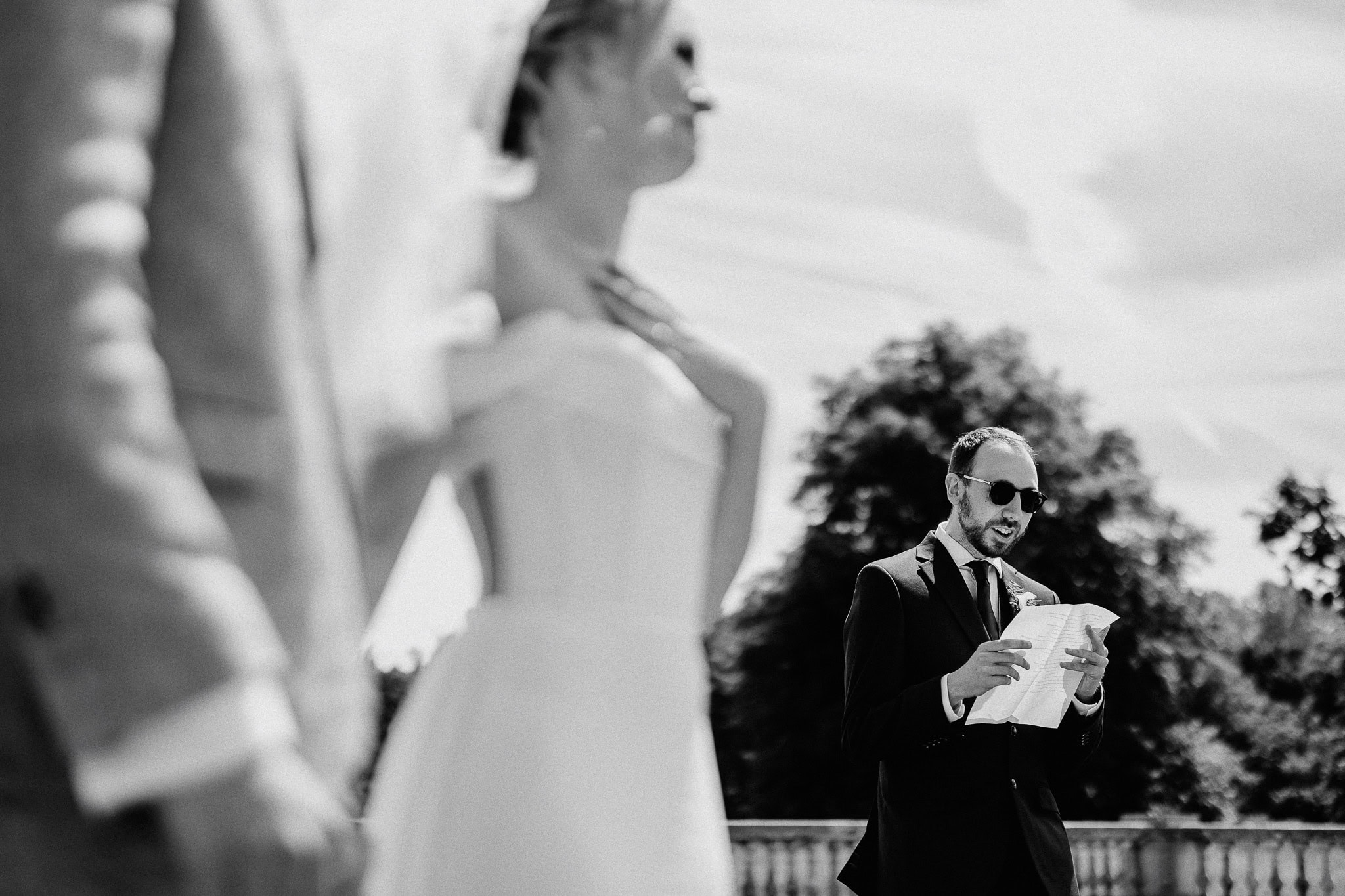 Groom's friend giving a speech at wedding ceremony.