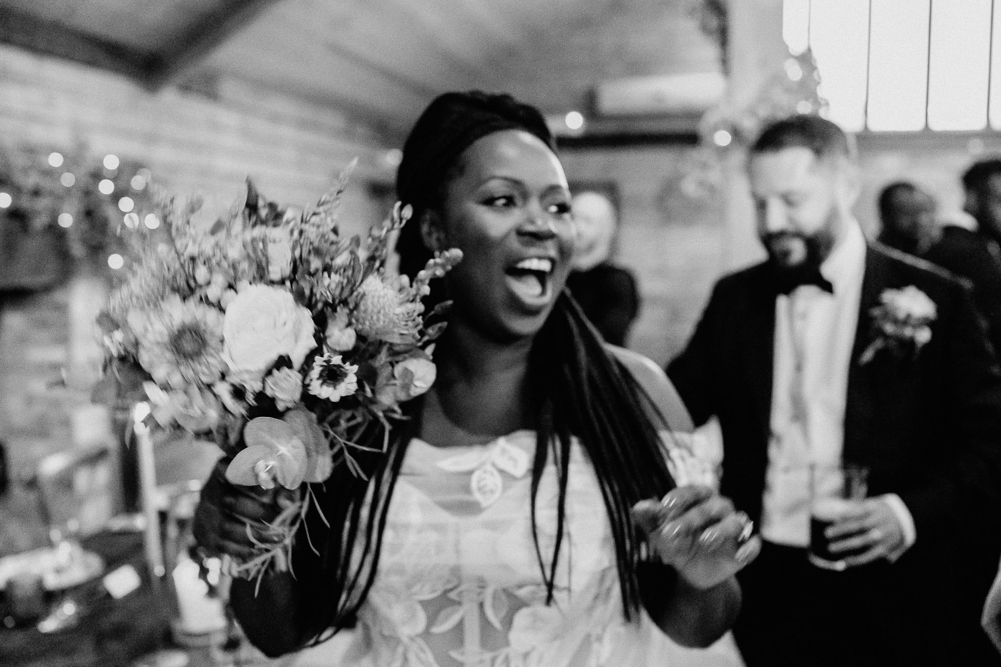 Joyful bride with bouquet, part of wedding photography portfolio.