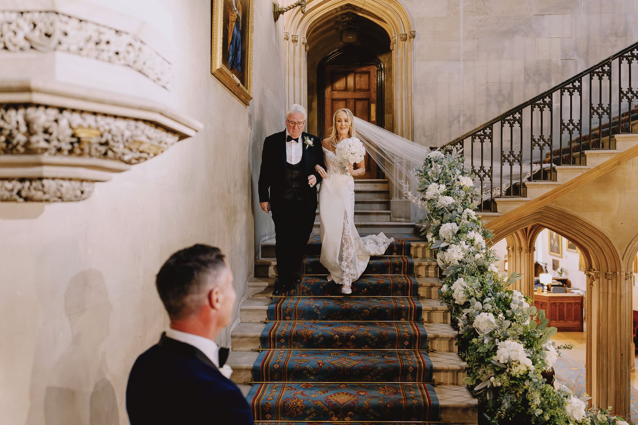 Bride and father walking down stairs for wedding photography portfolio
