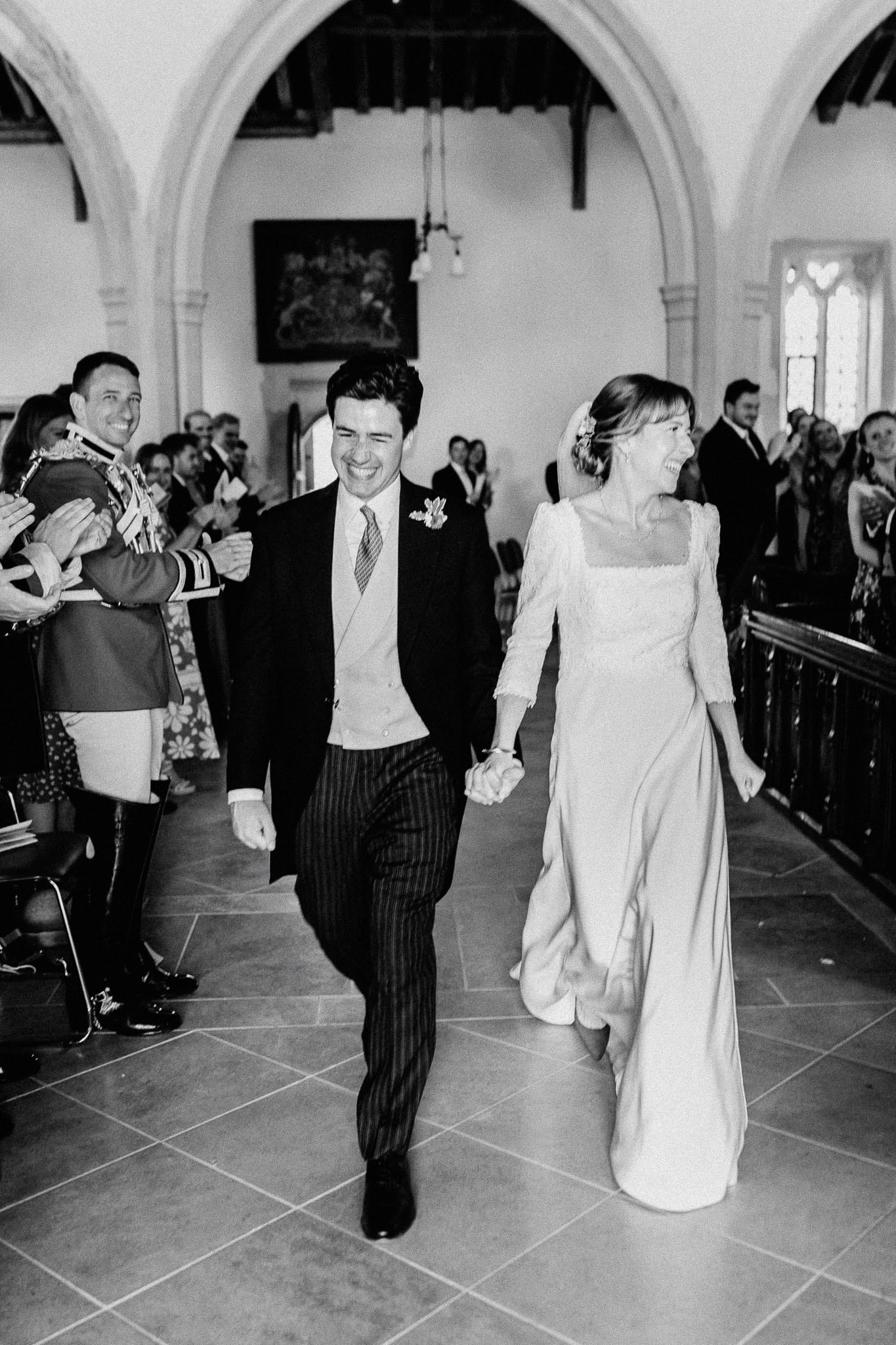 Bride and groom joyfully exit a church after their sustainable wedding ceremony.