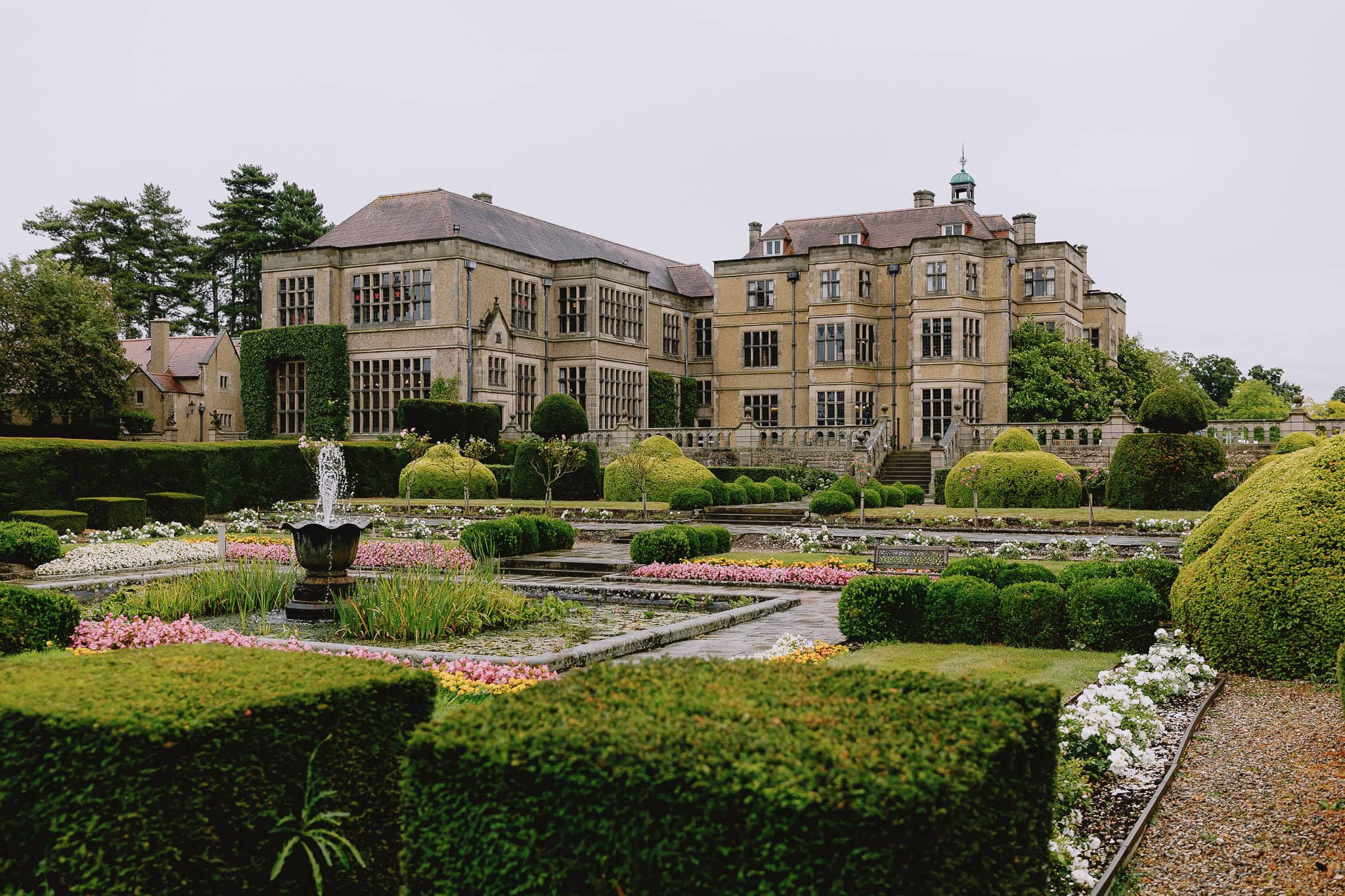 Fanhams Hall Wedding Photographer: Grand manor house with formal gardens and fountain.