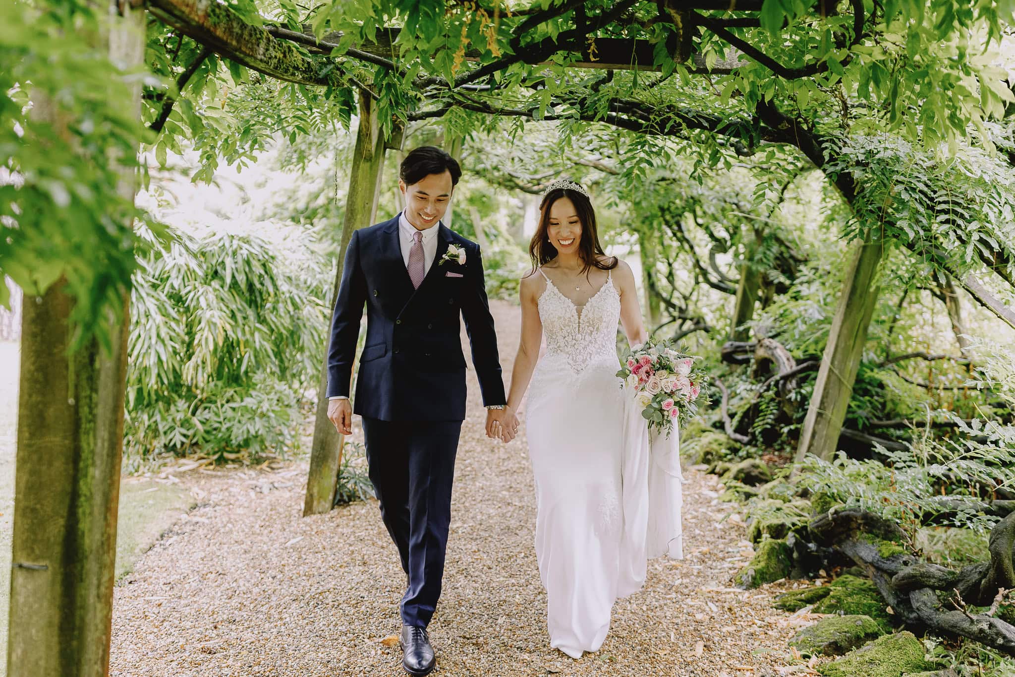 Happy couple walking hand-in-hand on their wedding day