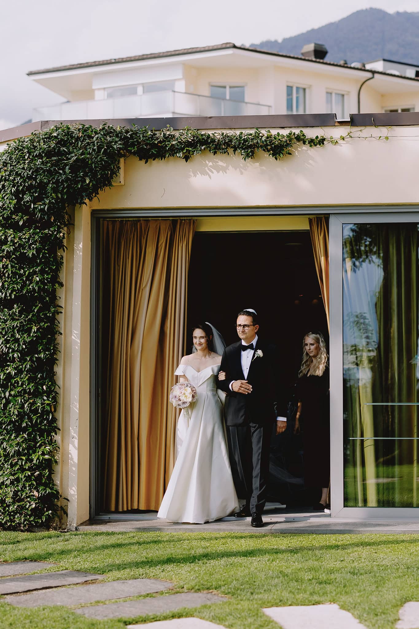 Bride and father walking down the aisle at an outdoor wedding.