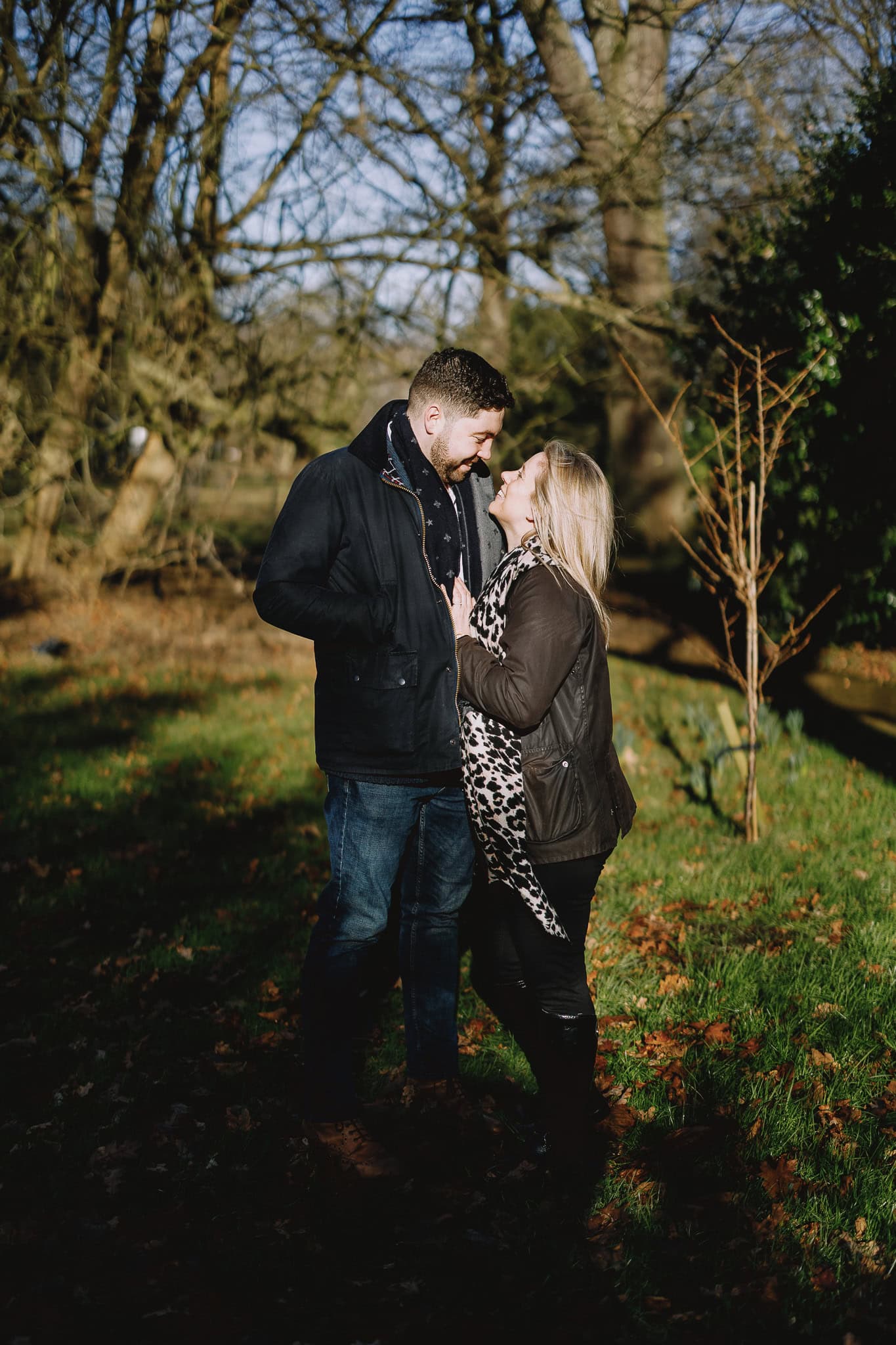 Couple in love, embracing in a park on a sunny day.