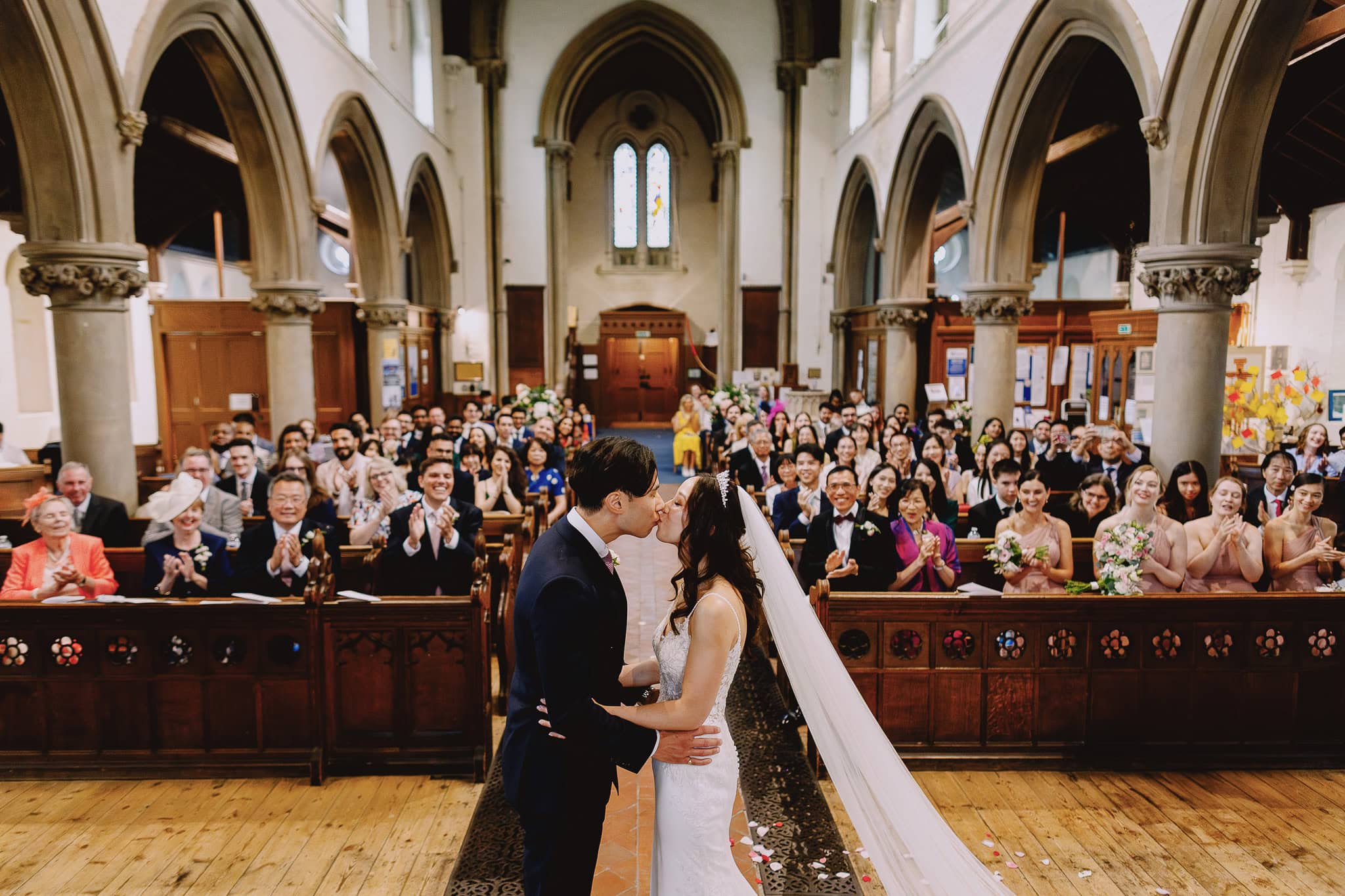 Couple kissing at their sustainable wedding with eco-friendly favors.