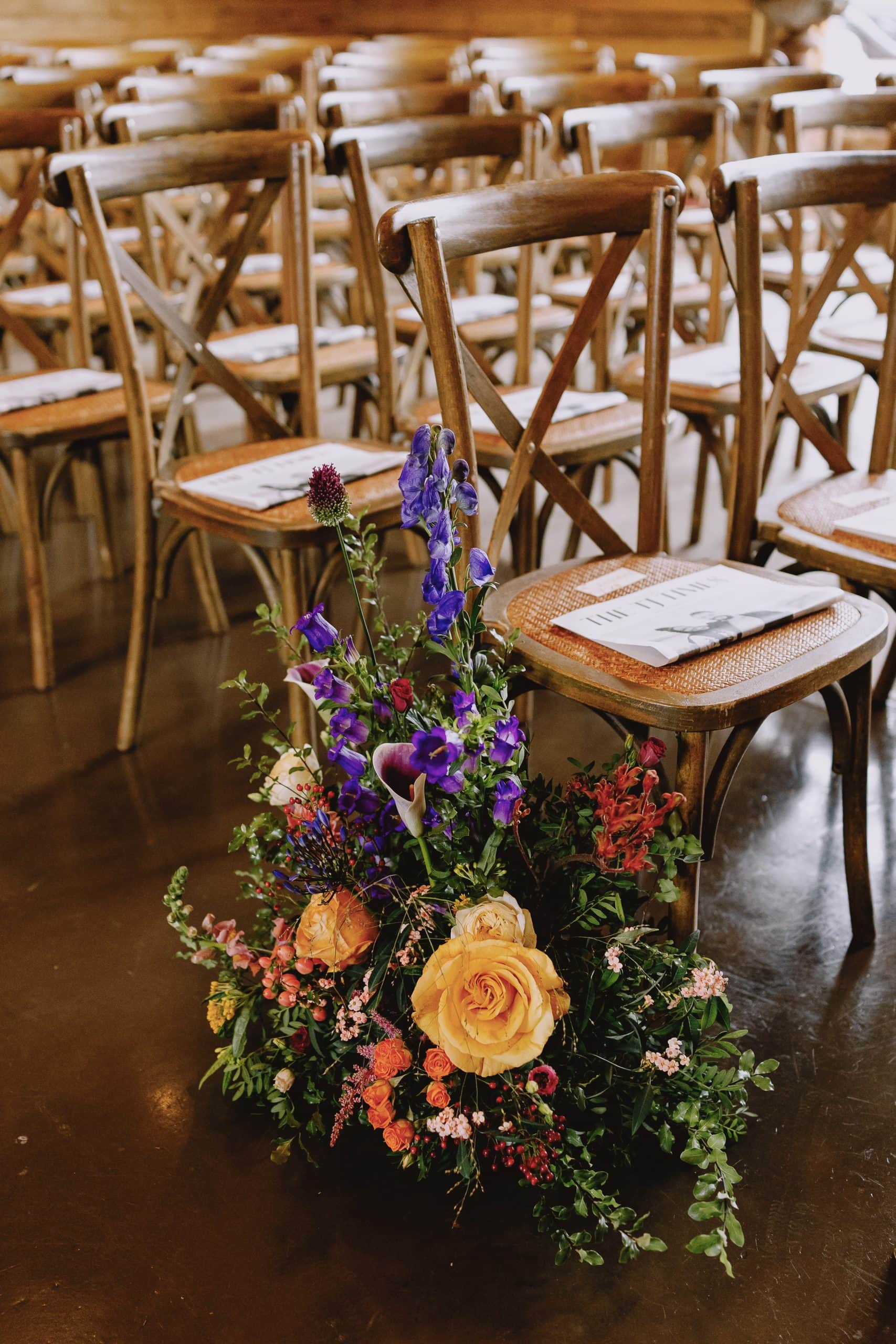 Wedding floral centerpiece with purple and yellow flowers on High Billinghurst Farm