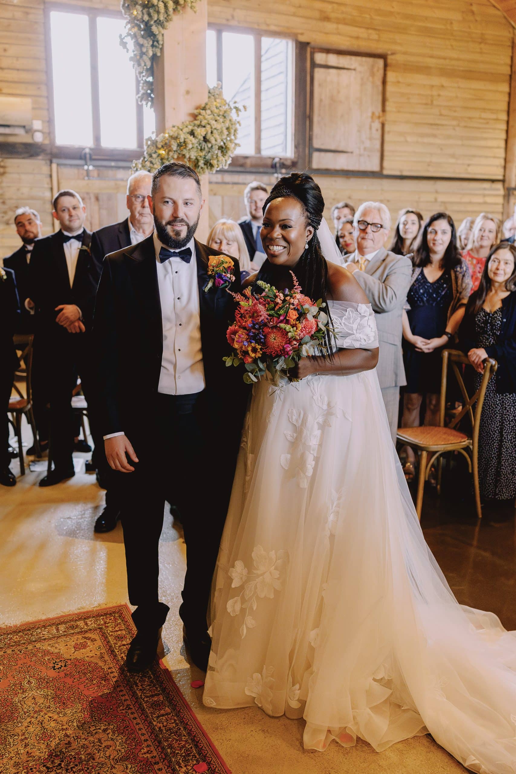 Bride and groom at High Billinghurst Farm Wedding holding flower bouquet