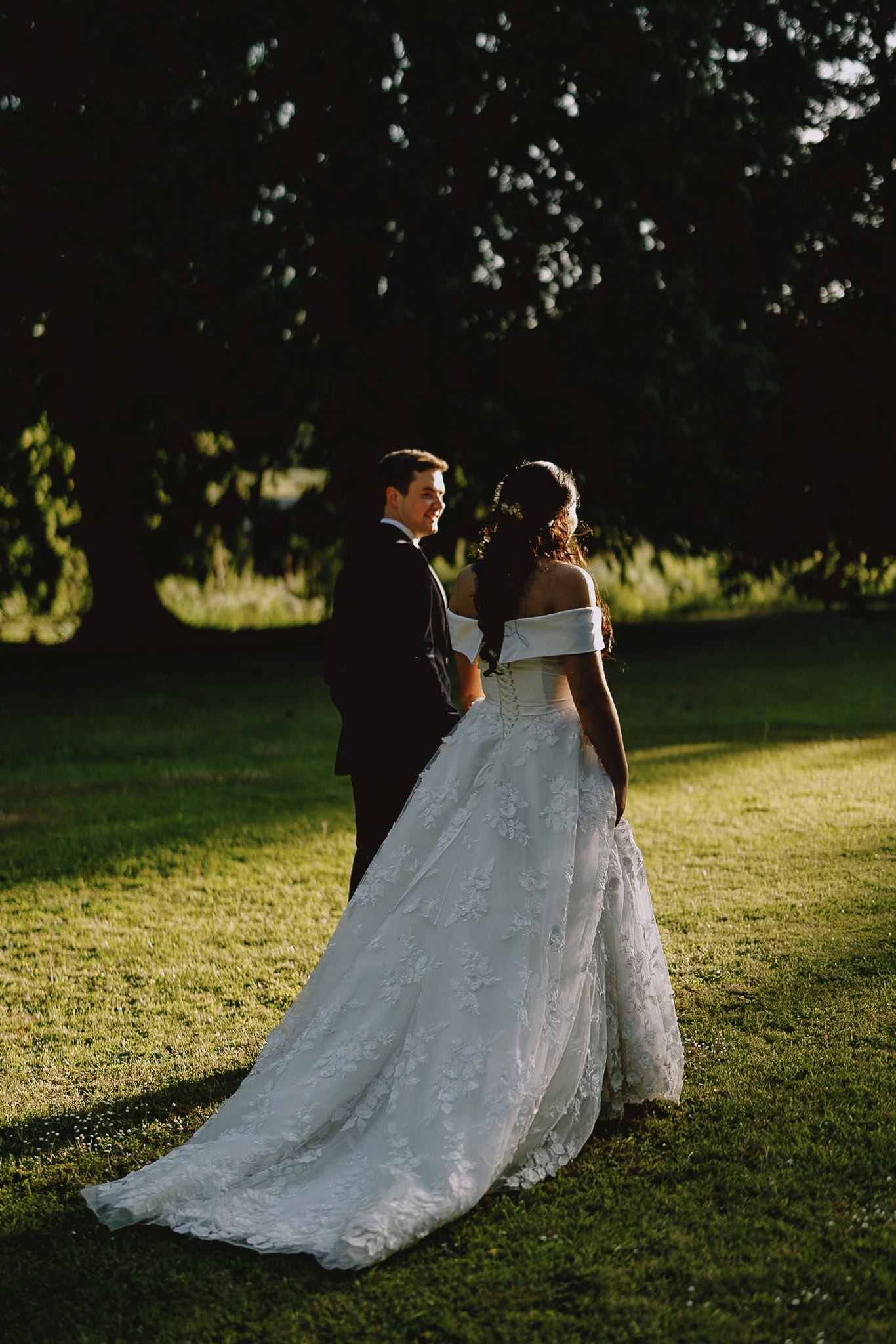 Bride and groom in a sunlit park, wedding photography